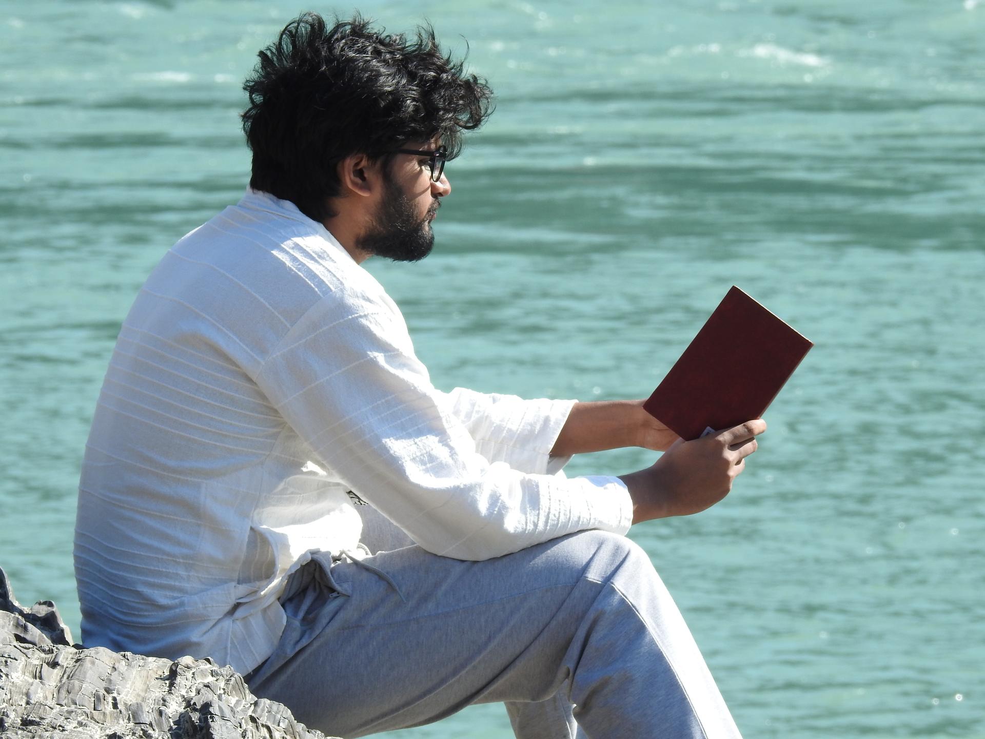 Founder reading outdoors by the water